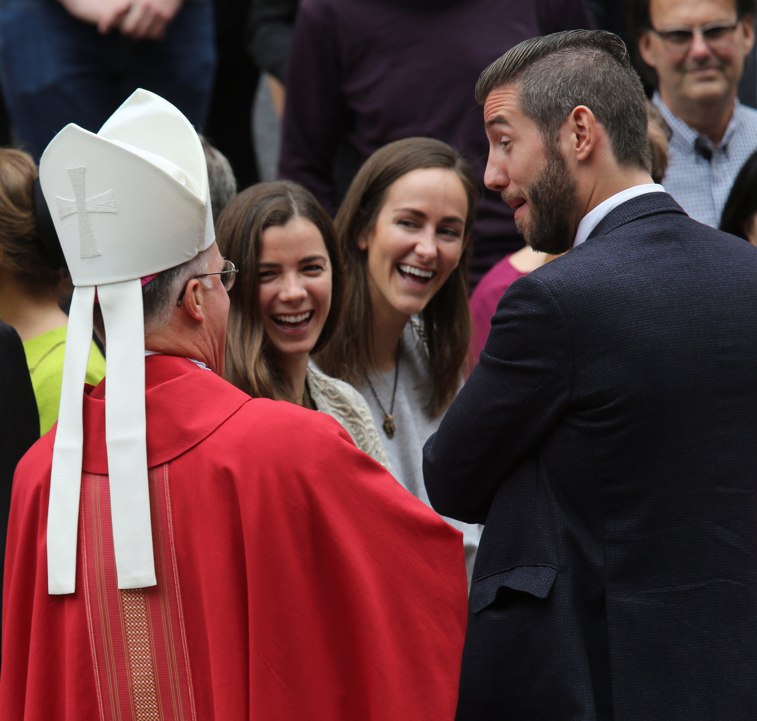 Archbishop Timothy P. Broglio of the U.S. Archdiocese for the Military Services shares a light moment with guests outside the Cathedral of St. Matthew the Apostle following the annual Red Mass in Washington Oct. 6, 2019. The Mass traditionally marks the start of the court year, including the opening of the Supreme Court term.